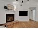 Bright living room shows a white brick fireplace and mantle with hardwood floors at 5929 Hatteras Dr, Port Orange, FL 32127