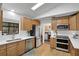 Well-lit kitchen features stainless steel appliances and wood cabinets at 5929 Hatteras Dr, Port Orange, FL 32127