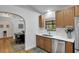 Bright kitchen featuring wood cabinets, quartz countertops, and stainless steel appliances at 5929 Hatteras Dr, Port Orange, FL 32127