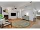 Spacious living room with fireplace, hardwood floors, and access to the kitchen at 5929 Hatteras Dr, Port Orange, FL 32127