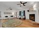 Bright living room with white brick fireplace, hardwood floors, and natural light at 5929 Hatteras Dr, Port Orange, FL 32127