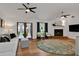 Bright living room with fireplace, hardwood floors, and doors to the outside at 5929 Hatteras Dr, Port Orange, FL 32127