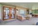 Comfortable screened patio featuring outdoor seating, string lights, and a tranquil view of the surrounding landscape at 5929 Hatteras Dr, Port Orange, FL 32127