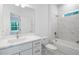 Bright bathroom featuring a modern vanity, a toilet, and a tiled shower and tub combination at 6929 Sw 130Th Lane Rd, Ocala, FL 34473