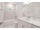 Bathroom with white marble tile, tub and shower combination, and modern fixtures at 6929 Sw 130Th Lane Rd, Ocala, FL 34473