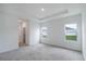Bright bedroom features neutral walls, gray carpet, and tray ceiling for a spacious and airy feel at 6929 Sw 130Th Lane Rd, Ocala, FL 34473