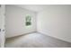 Bedroom with neutral walls, carpet, and natural light from a window at 6929 Sw 130Th Lane Rd, Ocala, FL 34473