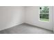 Bedroom featuring a window with natural lighting, neutral walls, and carpet at 6929 Sw 130Th Lane Rd, Ocala, FL 34473