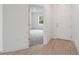 Bright entryway featuring wood-look floors and an open doorway to a carpeted room at 6929 Sw 130Th Lane Rd, Ocala, FL 34473