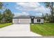 Charming single-story home with a well-manicured lawn and a two-car garage at 6929 Sw 130Th Lane Rd, Ocala, FL 34473