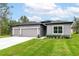 Lovely single-story home with a well-manicured lawn and a two-car garage at 6929 Sw 130Th Lane Rd, Ocala, FL 34473