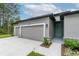 This two-car garage has stone accents and a charming, light teal front door at 6929 Sw 130Th Lane Rd, Ocala, FL 34473