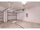 A clean, empty garage showcasing the door mechanics and electrical panel on the wall at 6929 Sw 130Th Lane Rd, Ocala, FL 34473