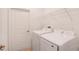 Bright laundry room featuring a modern white Samsung washer and dryer, plus wire rack storage at 6929 Sw 130Th Lane Rd, Ocala, FL 34473