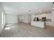 Expansive living area featuring modern flooring, bright white walls, and an adjacent kitchen with an island at 6929 Sw 130Th Lane Rd, Ocala, FL 34473