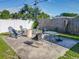 Backyard patio with patio chairs, fire pit, and outdoor dining table at 7033 Lakner Way, Orlando, FL 32822