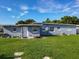 Back exterior of home with door opening to large, grassy, fenced yard at 7033 Lakner Way, Orlando, FL 32822