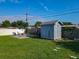 Backyard with shed, grassy lawn, and patio with patio furniture at 7033 Lakner Way, Orlando, FL 32822
