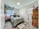 Cozy bedroom with wood-look flooring, neutral walls, and lots of natural light at 7033 Lakner Way, Orlando, FL 32822