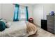 Comfortable bedroom features wood-look flooring and natural light at 7033 Lakner Way, Orlando, FL 32822