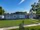 Charming single-story home with well-maintained lawn, freshly painted exterior, and freshly cemented driveway at 7033 Lakner Way, Orlando, FL 32822