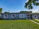 Charming single-story home with well-maintained lawn, freshly painted exterior, and freshly cemented driveway at 7033 Lakner Way, Orlando, FL 32822