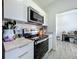 Bright kitchen with stainless steel appliances and white cabinetry at 7033 Lakner Way, Orlando, FL 32822