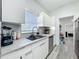 Modern kitchen with white cabinets, stainless steel appliances, and grey countertops at 7033 Lakner Way, Orlando, FL 32822