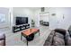 Modern living room with grey wood-look flooring, neutral walls, and comfortable leather seating at 7033 Lakner Way, Orlando, FL 32822