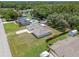 Aerial shot showcases home with neighboring pool, lush trees, and driveway at 7360 Canal Dr, Sanford, FL 32771