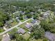 Aerial view of homes nestled among mature trees in a residential neighborhood, near a lake at 7360 Canal Dr, Sanford, FL 32771