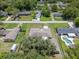 Bird's-eye view of a home with a sprawling backyard, mature trees, and a driveway at 7360 Canal Dr, Sanford, FL 32771