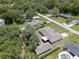 Aerial perspective showcasing the home's backyard, pool, trees, and driveway, set within the residential neighborhood at 7360 Canal Dr, Sanford, FL 32771