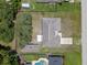 Aerial view of a home featuring a spacious yard, driveway, and a shed in a residential neighborhood at 7360 Canal Dr, Sanford, FL 32771