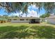 Expansive backyard with plenty of green space and a screened patio at 7360 Canal Dr, Sanford, FL 32771