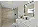 Bathroom with updated shower featuring bright marble and updated fixtures at 7360 Canal Dr, Sanford, FL 32771