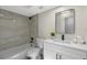 Updated bathroom featuring marble-style shower-tub and black fixtures at 7360 Canal Dr, Sanford, FL 32771