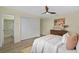 Bright bedroom featuring a ceiling fan, stylish dresser, and comfortable-looking bed at 7360 Canal Dr, Sanford, FL 32771