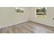 Well-lit empty bedroom with hardwood flooring and two large windows at 7360 Canal Dr, Sanford, FL 32771