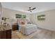 Cozy bedroom featuring hardwood floors, neutral decor, windows and ceiling fan at 7360 Canal Dr, Sanford, FL 32771