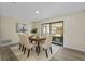 Well-lit dining room showcasing a table with six chairs and access to the screened patio at 7360 Canal Dr, Sanford, FL 32771