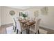 Dining area featuring a modern table with six chairs, hardwood floors, and contemporary decor at 7360 Canal Dr, Sanford, FL 32771