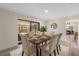Well-lit dining area with a view to the screened patio, table with six chairs and hardwood floors at 7360 Canal Dr, Sanford, FL 32771