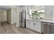 Bright kitchen features stainless steel appliances, white cabinets, and quartz countertops by a window at 7360 Canal Dr, Sanford, FL 32771
