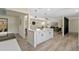 Open floor plan showcasing the kitchen island with white cabinets and a view to the living room at 7360 Canal Dr, Sanford, FL 32771