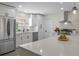 Modern kitchen featuring white cabinets, stainless steel appliances, and a large island at 7360 Canal Dr, Sanford, FL 32771