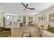 Inviting living area features a modern ceiling fan, wood flooring, and an open layout to the adjacent kitchen at 7360 Canal Dr, Sanford, FL 32771