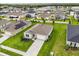 An aerial view highlights a home with a driveway, green lawn, and solar panels at 756 Rioja Dr, Minneola, FL 34715