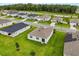 An aerial shot of a home showcasing a well-manicured lawn and roof with solar panels at 756 Rioja Dr, Minneola, FL 34715