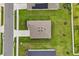 Aerial view featuring a detailed roof with vents, a driveway, and verdant lawn at 756 Rioja Dr, Minneola, FL 34715